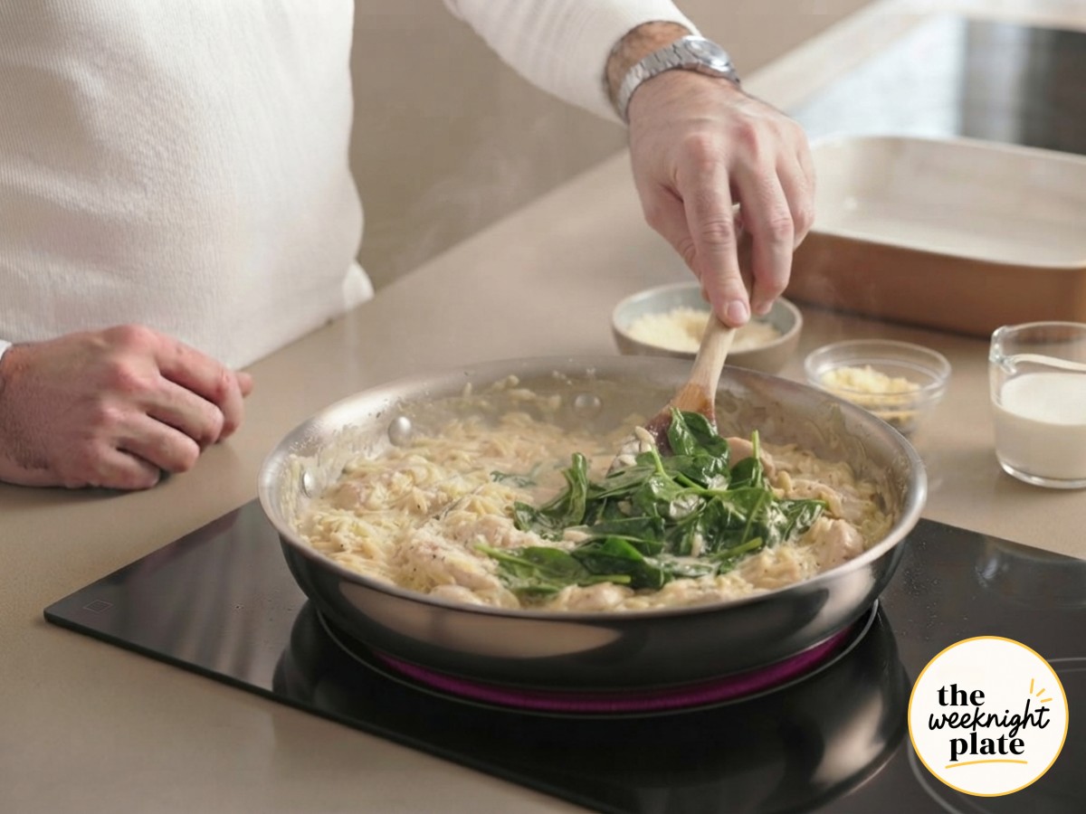Fresh spinach and parmesan stirred into the creamy orzo as it wilts down right in the same skillet.
