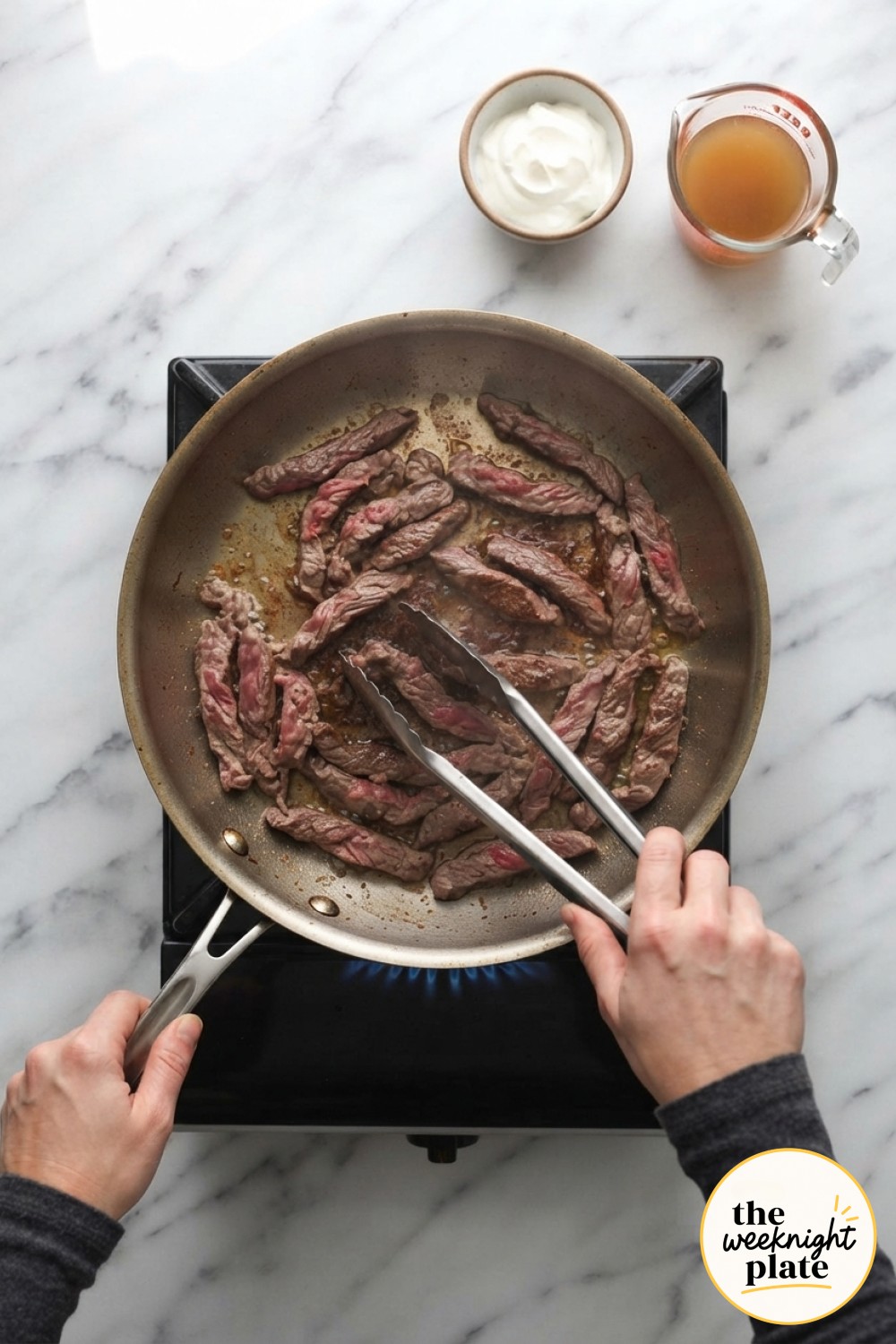 Beef strips sear hard and fast in a hot skillet, the first cooking step in this low carb beef stroganoff.