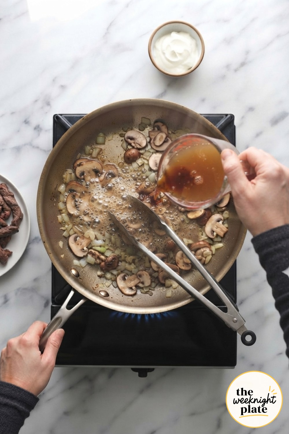 Beef broth and Worcestershire pour into the mushroom pan, deglazing the base for a low carb beef stroganoff sauce.