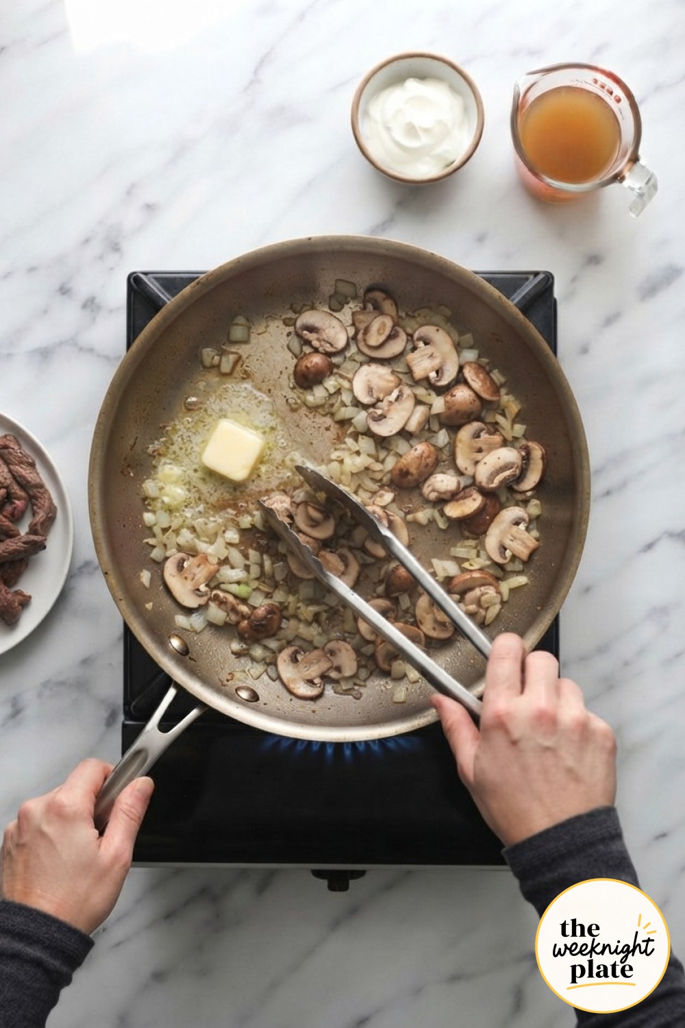 Mushrooms and onions turn golden in butter after the seared beef is removed from the low carb stroganoff pan.